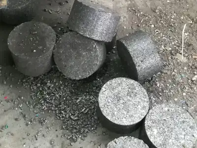 Aluminium granules compressed into dense cylindrical briquettes