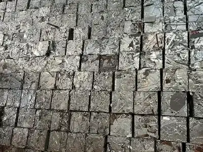 Wall of compact aluminium scrap bales prepared for recycling