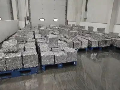 Aluminium scrap bales arranged on pallets after hydraulic compression