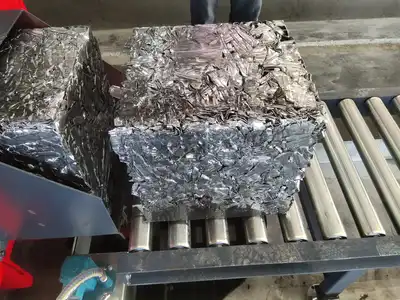 Freshly discharged aluminium scrap bale on a roller conveyor