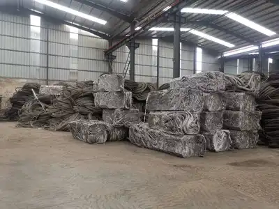 Stacked aluminium wire bales in a recycling warehouse