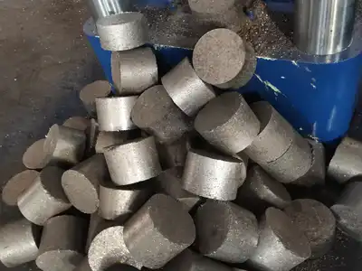 Cast iron briquettes discharged beside the briquetting press