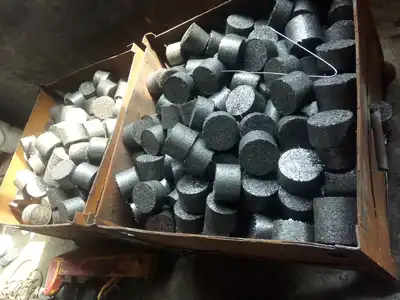 Cast iron chip briquettes collected in a steel bin