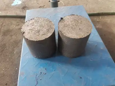 Paired cast iron briquettes after hydraulic pressing