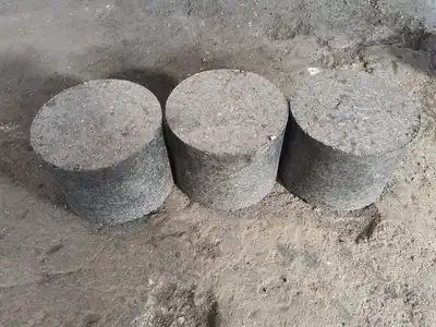 Three dense cast iron swarf briquettes