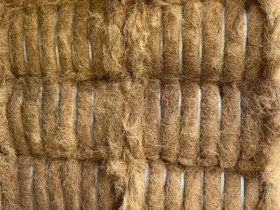 Closely stacked tied coir fibre bales