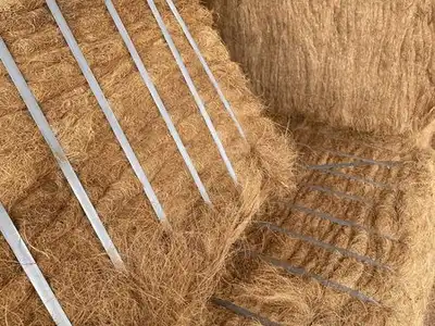 Dense coir fibre bales secured with metal straps