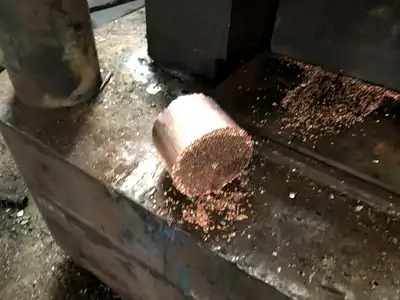 Copper briquette discharged from a hydraulic press