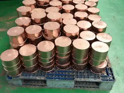 Copper briquettes stacked on a pallet for shipment