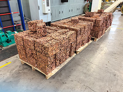 Compressed copper turnings bales arranged in a factory