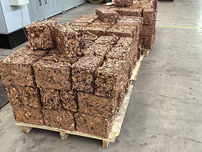 Rectangular copper turnings bales on a pallet