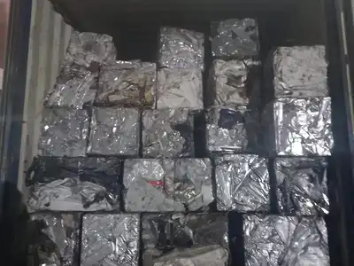 Light scrap metal bales loaded inside a shipping container