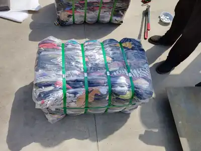 Fresh old clothes bale tied with plastic straps