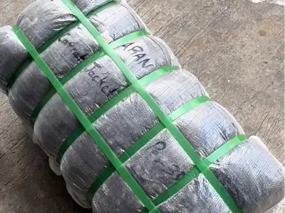 Old clothes bale secured with green plastic straps