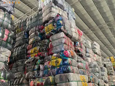 High stacks of compressed old clothes bales