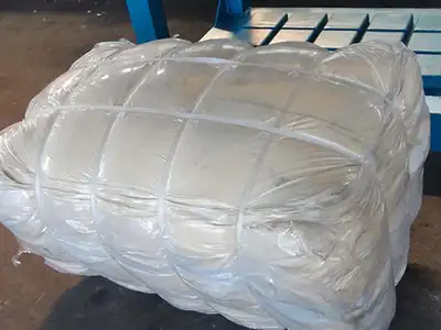 White textile bale secured after compression
