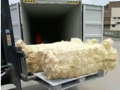 Forklift handling a compressed sisal fibre bale