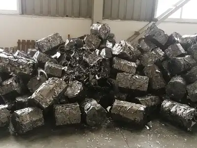 Compact rectangular stainless steel bales in a processing facility
