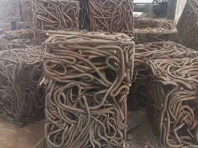 Bent reinforcing bar compressed into rectangular bales