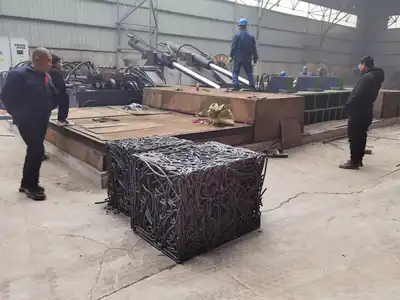 Dense steel bar bale discharged from a hydraulic baler