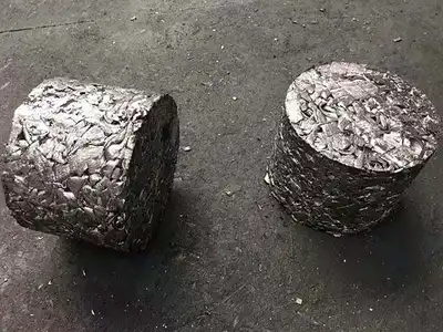 Two compact steel chip briquettes after pressing