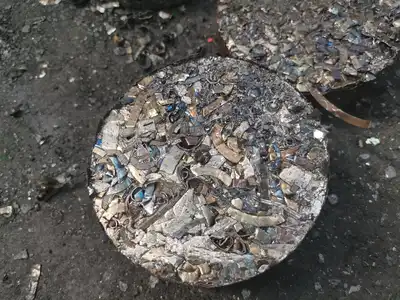 Steel machining chips compressed into a dense cylindrical briquette