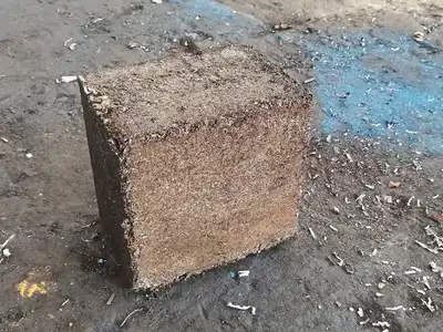 Dense ferrous shaving bale after hydraulic compression