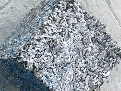 Compressed steel shavings visible in a rectangular bale