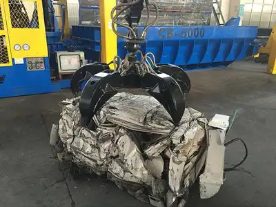 Car bale being removed from a professional automobile baler