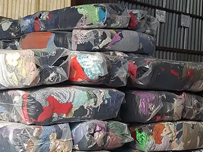 Large bagged wiping-rag bales stacked in a warehouse