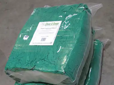 Small clear bag of compressed green wiping rags