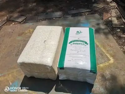 Compressed shavings block beside a finished bagged bale