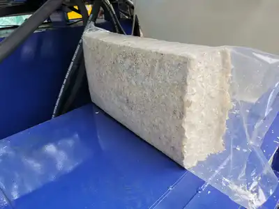 Compressed wood-shavings block entering a plastic bag