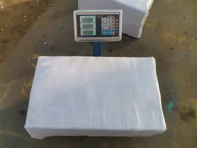 Finished wood-shavings package during weight verification