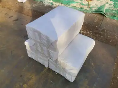 Wrapped compressed wood-shavings blocks ready for shipment