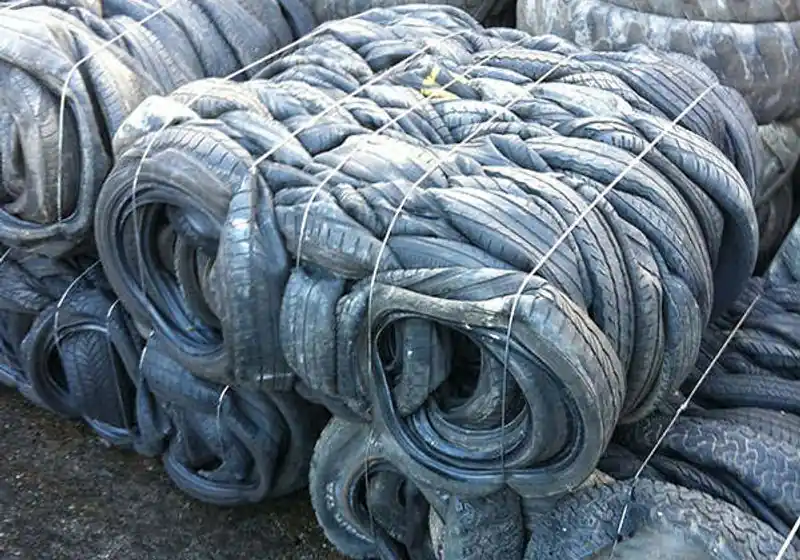 Compressed waste-tire bale held by retaining ties