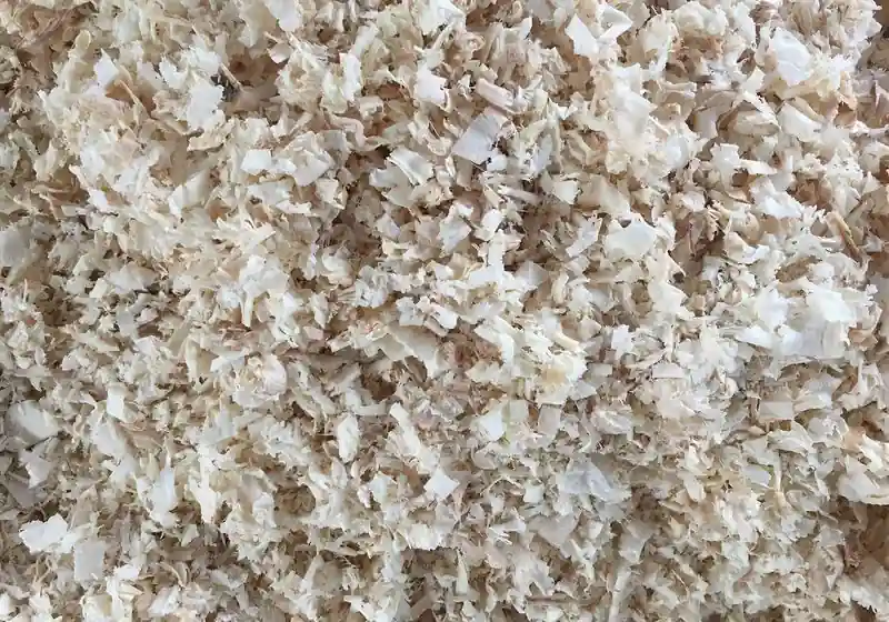 Loose pale wood shavings before compression and bagging