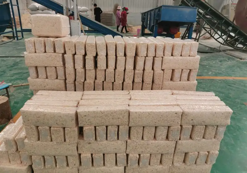 Rows of compressed wood shavings packages stacked in a workshop