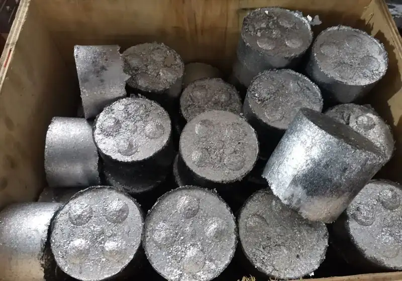 Close-up of cylindrical briquettes formed from compressed aluminium turnings
