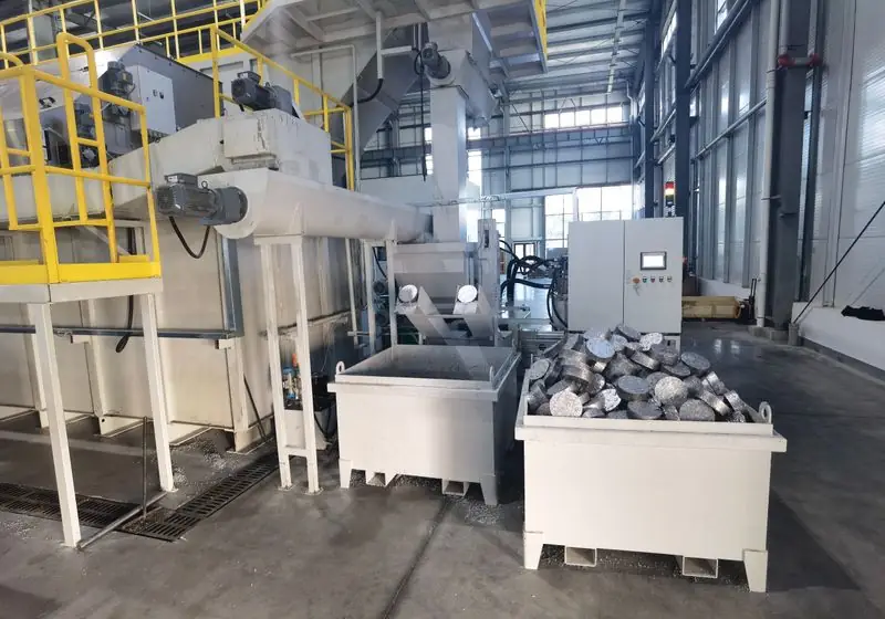 Double outlet briquetting equipment with two discharge chutes and receiving containers