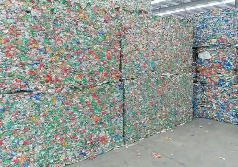 Rectangular compressed aluminium beverage-can bales arranged in storage
