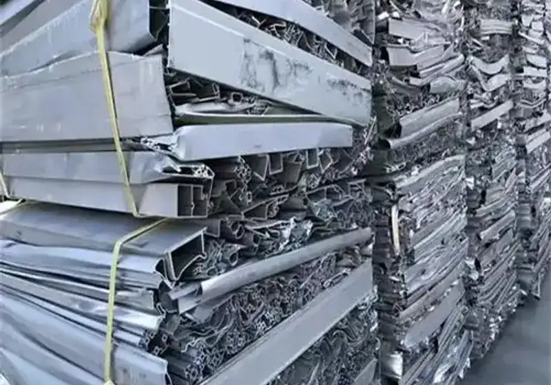 Close-up of tied aluminium profile scrap compressed into rectangular bales
