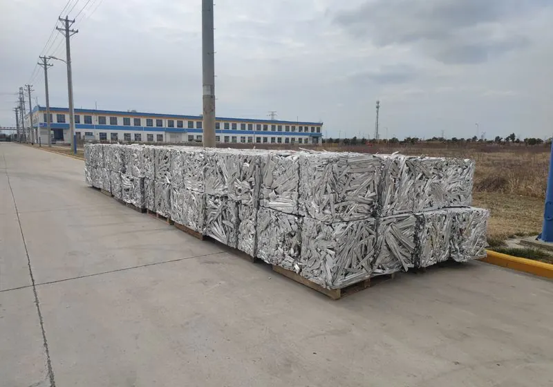 Rows of compressed aluminium profile packages placed on pallets