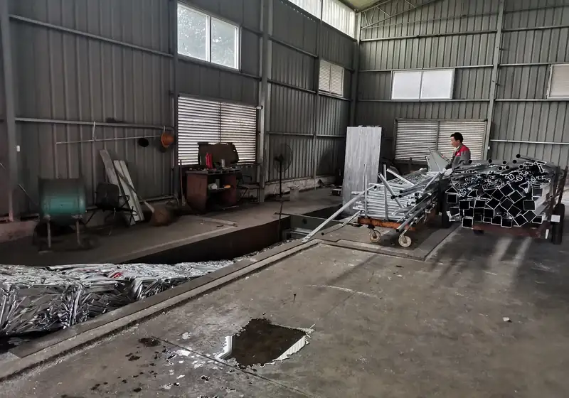 Aluminium extrusion profiles on a trolley beside the baling and package collection area