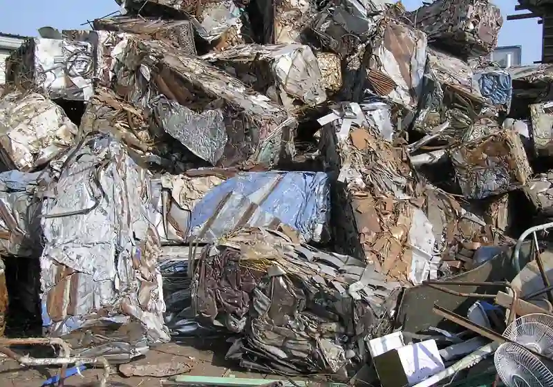 Compacted mixed iron and steel scrap packages collected in a recycling yard