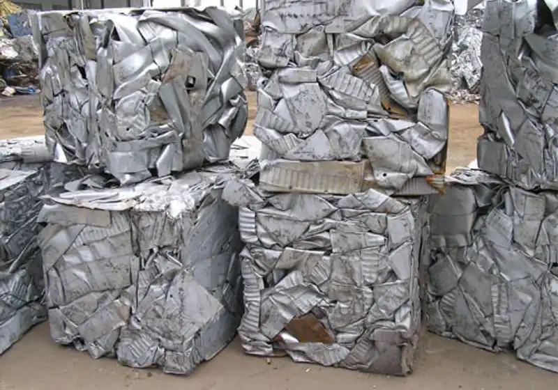 Rectangular compressed sheet-metal scrap bales arranged in rows