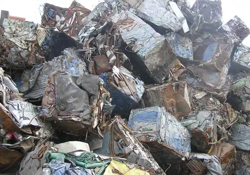 Compacted mixed-ferrous scrap bales gathered in a recycling yard