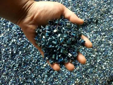 Hand holding curled steel machining chips before briquetting