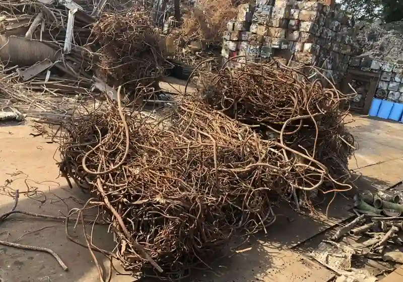 Tangled waste reinforcing bars and mixed ferrous scrap in a recycling yard