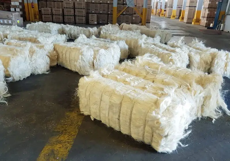 Compressed sisal fiber bales arranged in a warehouse
